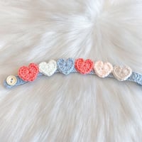 Decorated with crocheted colorful hearts in pink and light blue